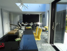 Kitchen and open plan living area, pale grey and black open plan kitchen