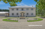 Exterior of house and grand front yard painted in Resene Quarter Spanish White