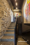 entranceway, stairwell, grey hallway, brown hallway, concrete floor, brick feature wall