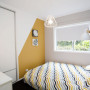 bedroom, orange bedroom, orange paint, feature wall, geometric pattern, white bedroom