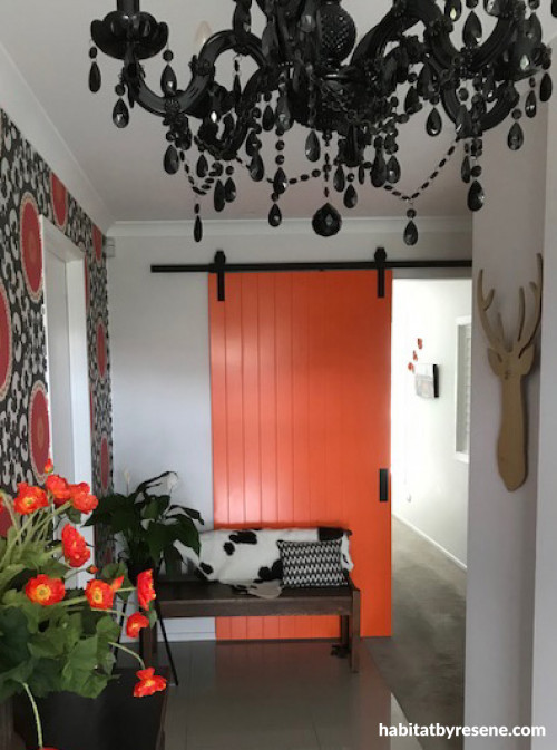 orange barn door, white walls, orange paint, rustic door, resene tangerine